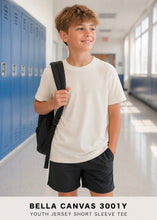 Load image into Gallery viewer, Bella Canvas Youth Tee worn by boy in school hallway
